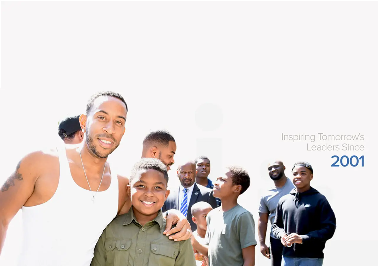 Ludacris stands with a child. A group of people stand in the background. Text reads 'Inspiring Tomorrow's Leaders Since 2001.'